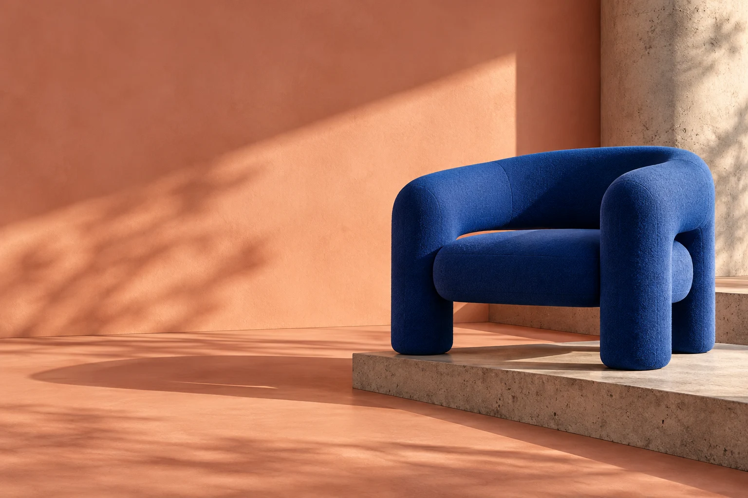 Kobaltblauwe sculpturale fauteuil in een zonovergoten perzikkleurige ruimte